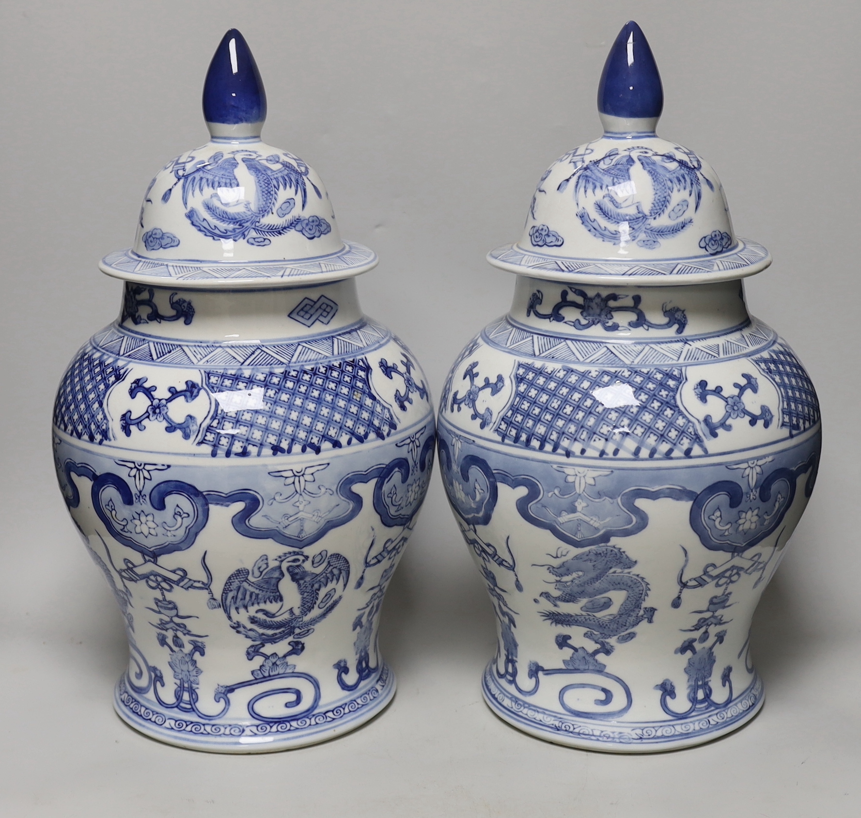 A pair of Chinese blue and white baluster vases and covers, 45cm high